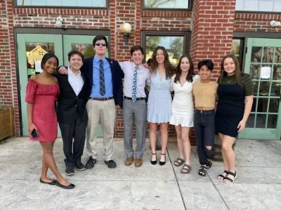 CCWA group shot of 8 members outside in formal wear 